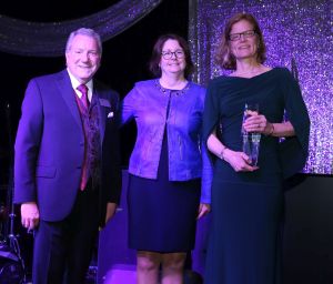 Photo of Dr. Kristin Bloink accepting the 2019 AKC Canine Health Foundation's President's Award from Board Chairman Dr. Charles Garvin and CHF Chief Executive Officer, Dr. Diane Brown.