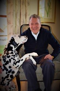 Photo of Dr. Garvin at home with one of his Dalmatians