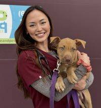 Photo of Courtney Labe holding a puppy