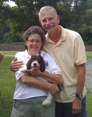Photo of Dr. Laura Liscum with her partner, Dr. Jerry Faust, and one of their dogs.